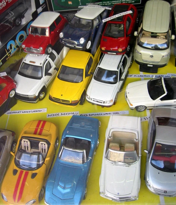 some cars are shown on display in a case