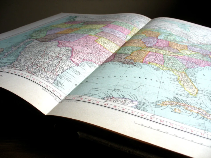 an open book with a map on top