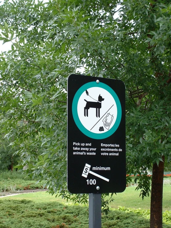 a black sign with a white sticker below it