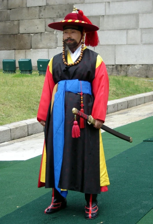 a man with a sword standing on a green surface