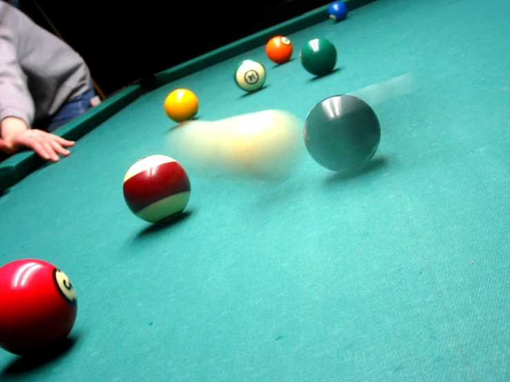 a pool table has several colorful balls arranged on it