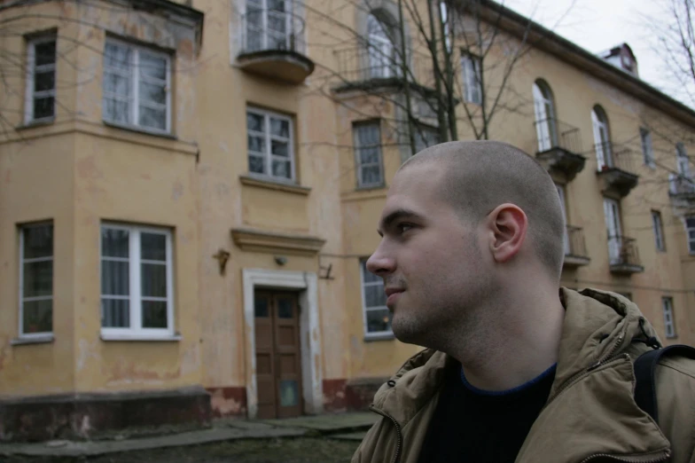 a man in front of a building with no windows