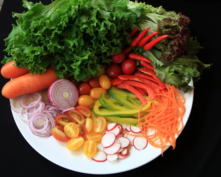 there are vegetables on the plate as a fruit and vegetable salad