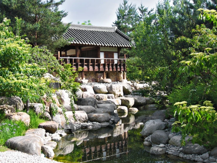 small wooden pavilion with railing and railings over water