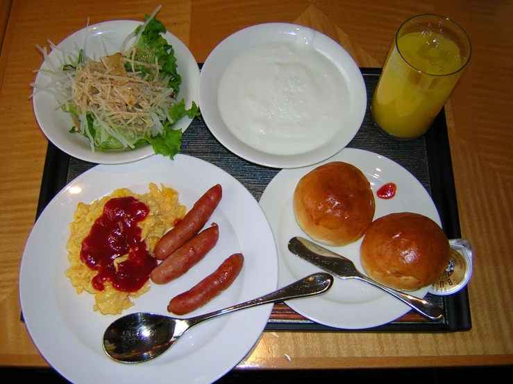 a table with different food on it, some plates with meat, some with rice and another on it