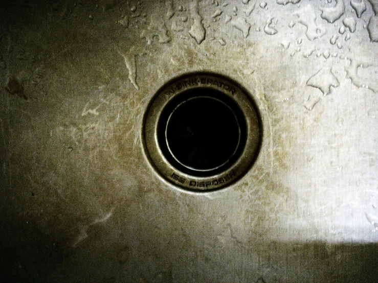 a sink with round drain sitting in the middle of it