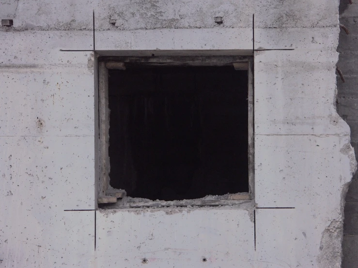 white and grey bricks surrounding a window in an area