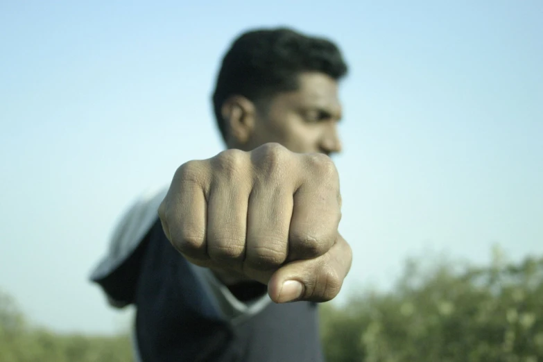 a man is pointing with the finger towards the camera