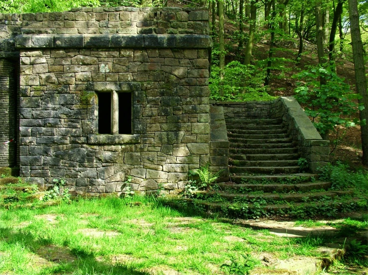 a brick building with many windows and steps going up the side