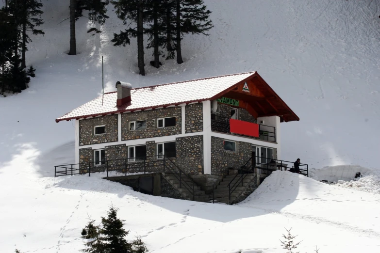 a building on top of a snow covered slope