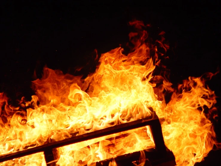 a bright and colorful fire burning over a street light