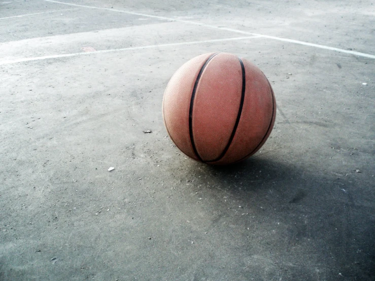 an outdoor basketball game being played on concrete