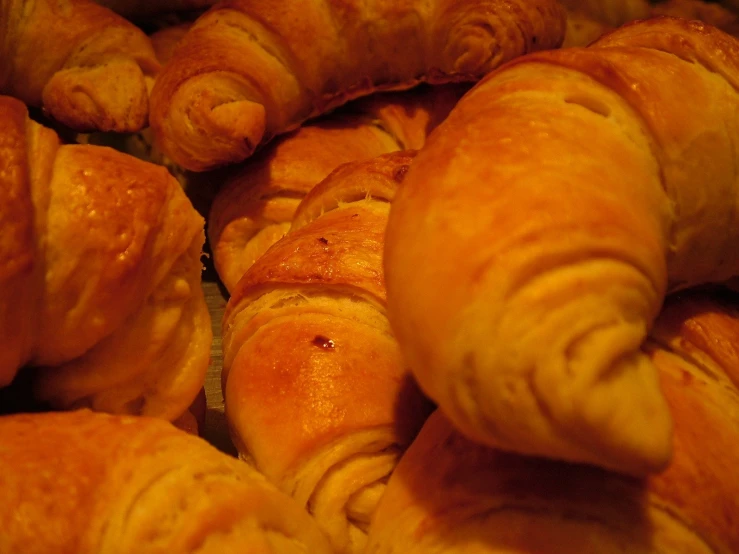 an assortment of pastries are arranged in rows