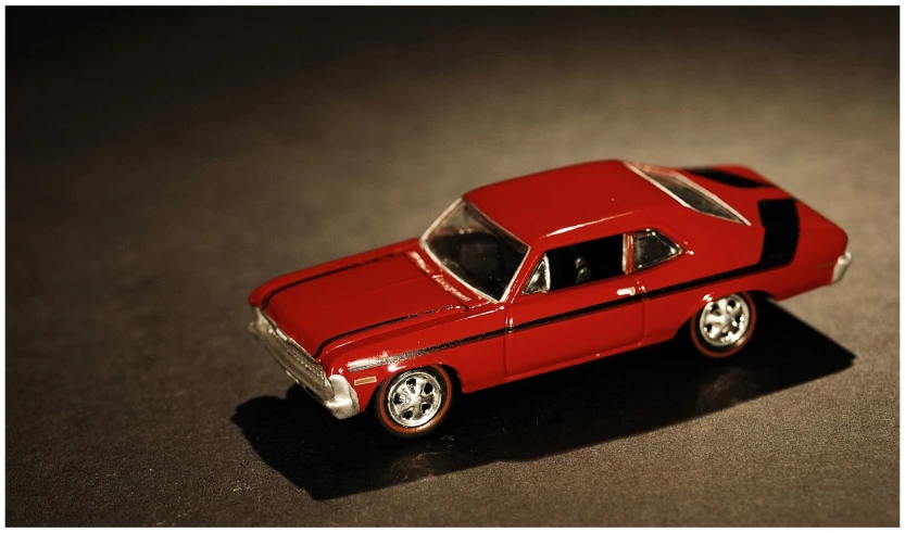 red toy car on table with dark background