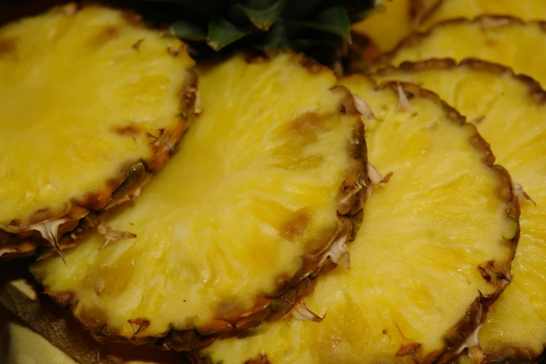 a close - up of sliced pineapple on a plate