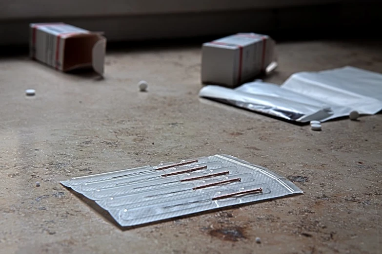 a metallic piece of tin foil sitting next to two red packets