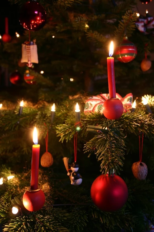 a collection of christmas decorations sitting in front of a tree