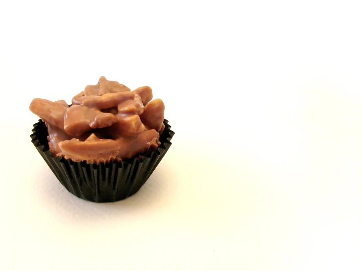 a close up of a cupcake on a white surface