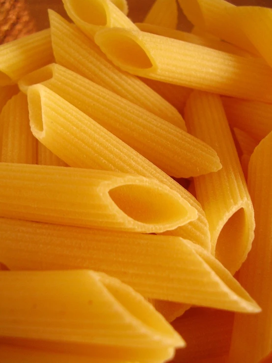 a close up of some pasta with yellow sauce