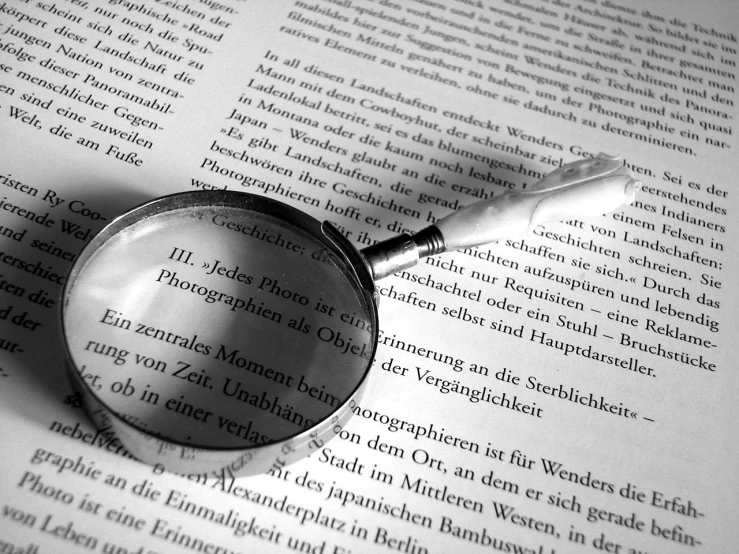 the magnifying glass is lying on top of a book