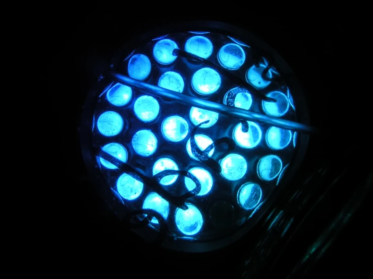 a close up of a bright, round object lit with blue light