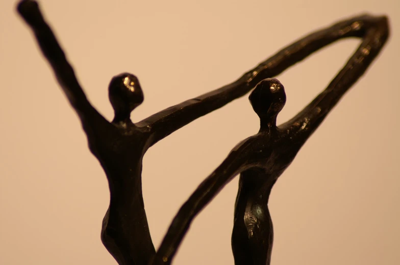 an artistic sculpture of two people holding hands