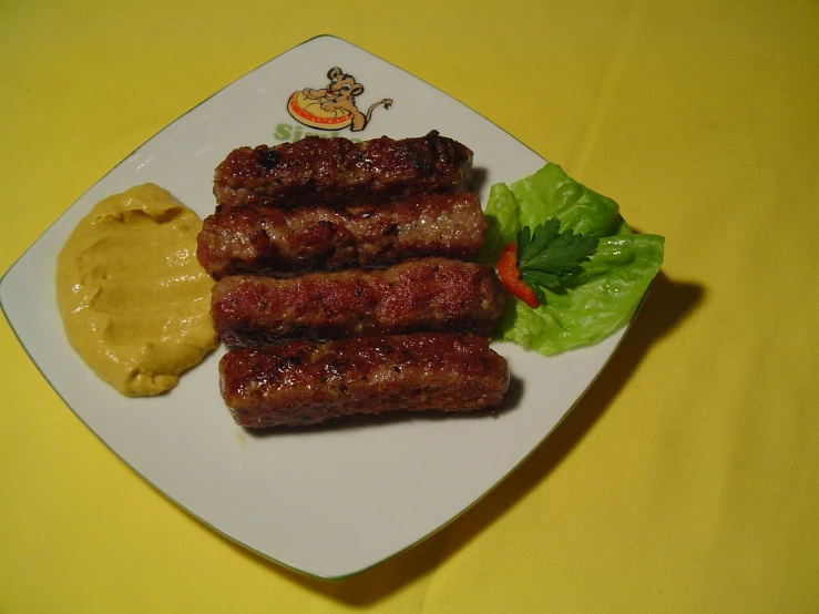 a plate of food with lettuce and sauce