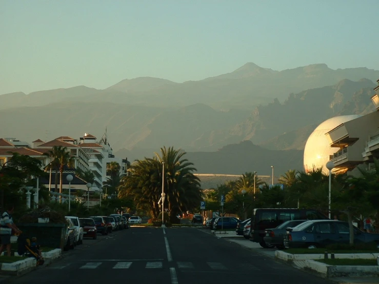 many vehicles are on the street by some buildings