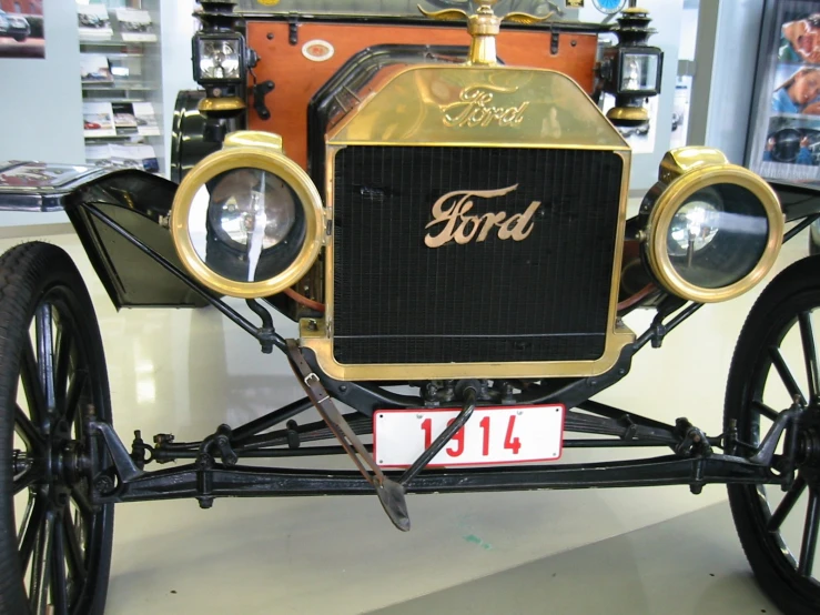 a vintage ford automobile sits on display