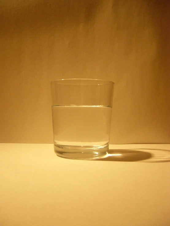 a clear glass of water on a white table