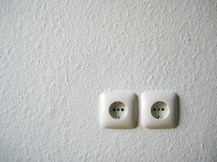 two switches that are on a wall