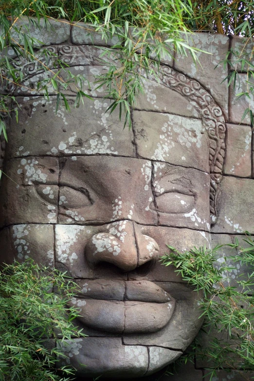 the head is carved into a rock wall