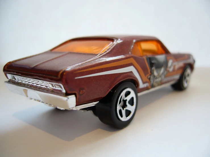 a toy car on a white surface with a red background