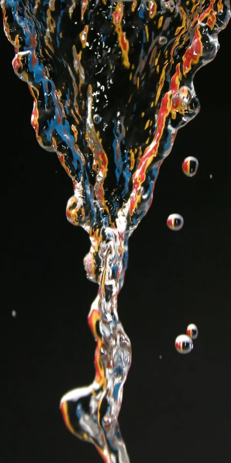 water drops into a glass with black background