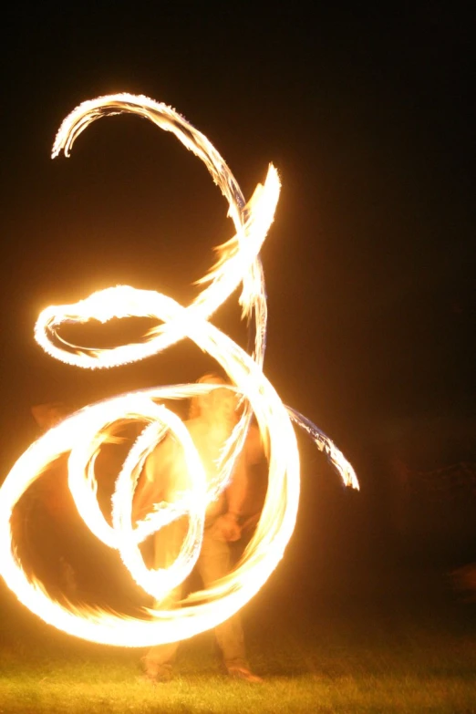 a person dancing in the dark with light painting on their face