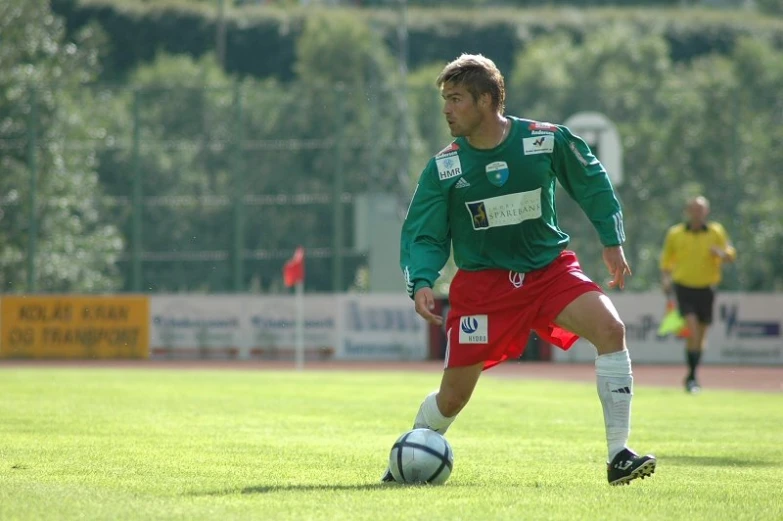 a person standing in a field playing soccer