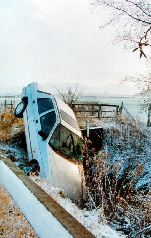 a vehicle crashed in the ditch of a dirt ditch