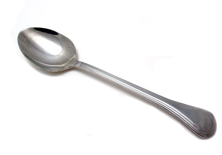 a silver spoon with metal handle on a white background