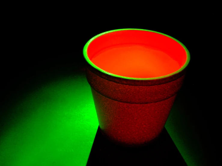 a green and red cup with no lid