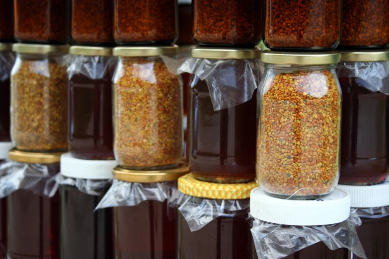 a row of jars filled with lots of liquid