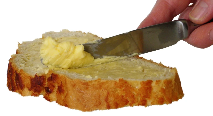 a knife is being used to cut a piece of bread