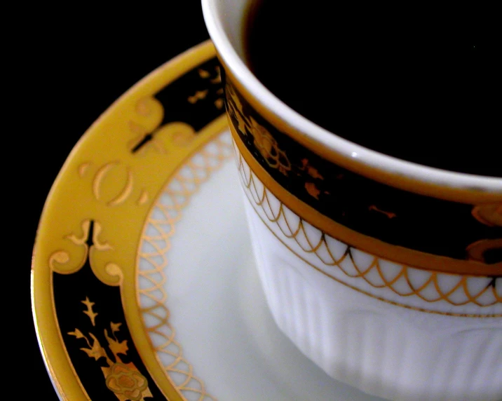 coffee cup on yellow and black plates on a dark background