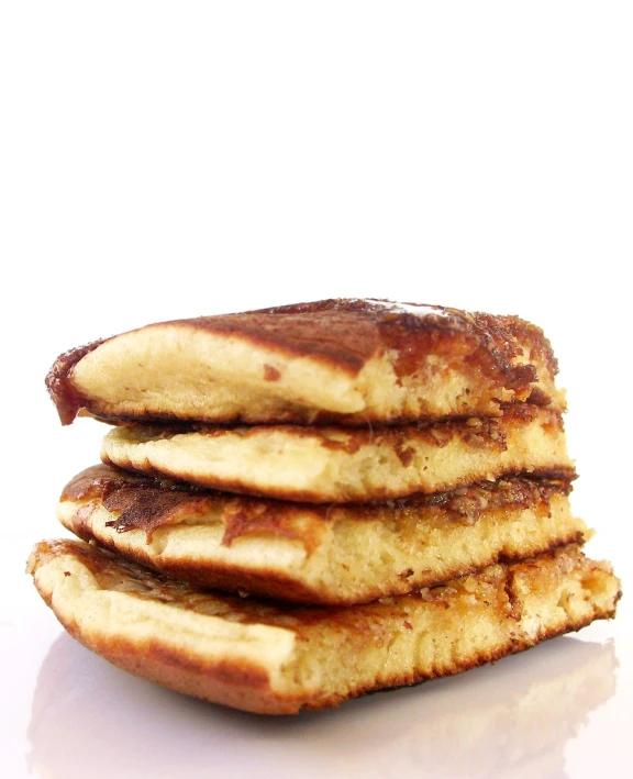 a stack of pancakes sits on a white plate