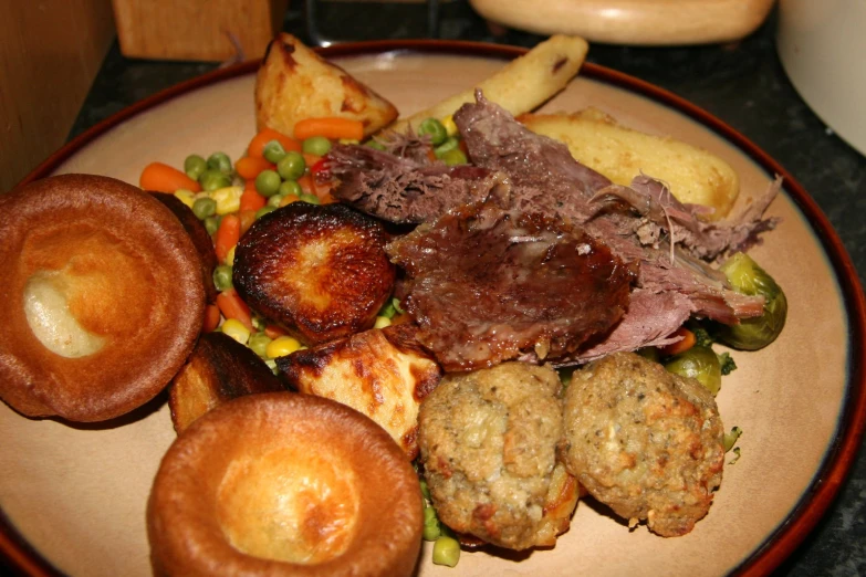 a meal on a white plate, complete with meat, potatoes, and vegetables