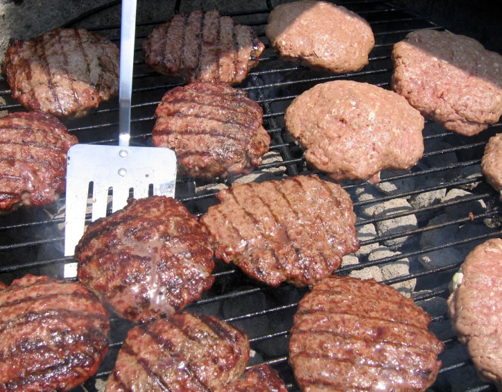 hamburger and burger patties cooking on the grill