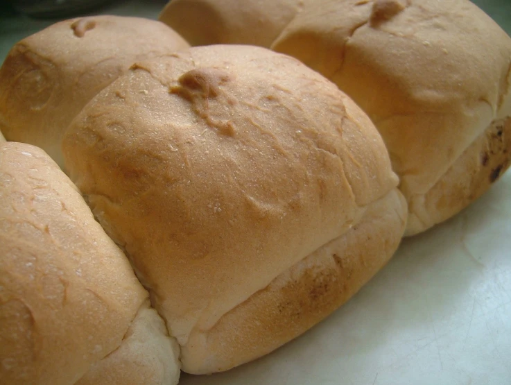 four small round rolls stacked on top of each other