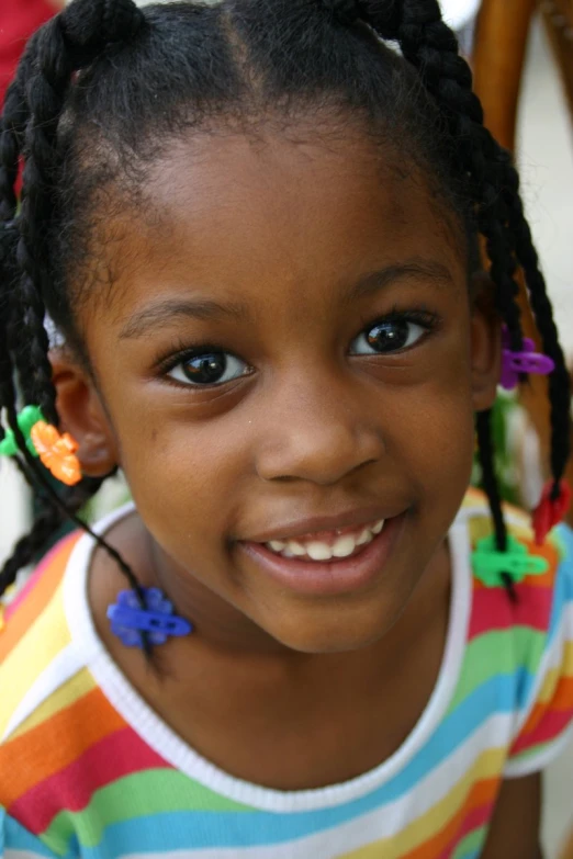 a little girl with big blue eyes smiling