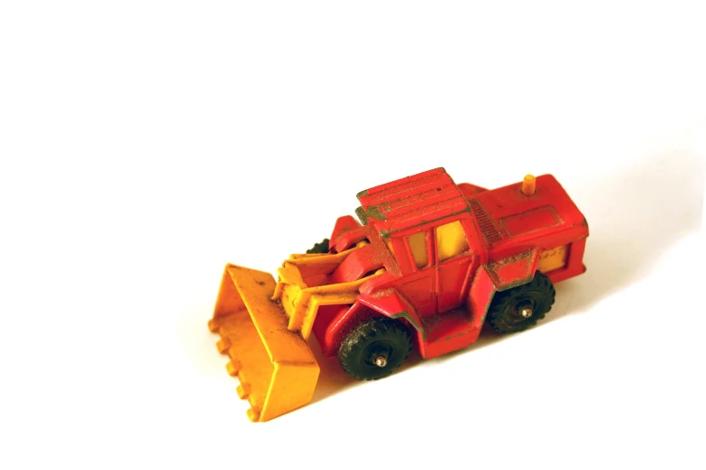 toy red and yellow vehicle on white background