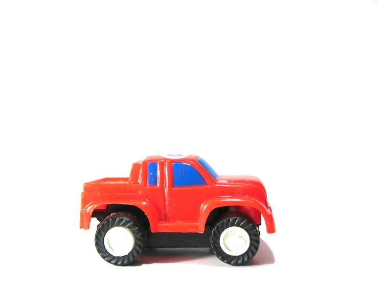 a red plastic toy car with two wheels
