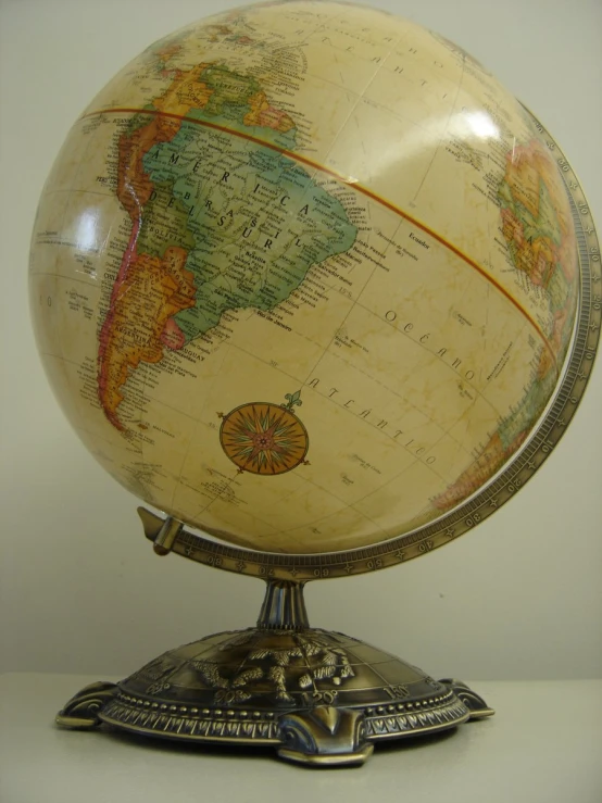 a terrestrial globe sitting on a stand in a room